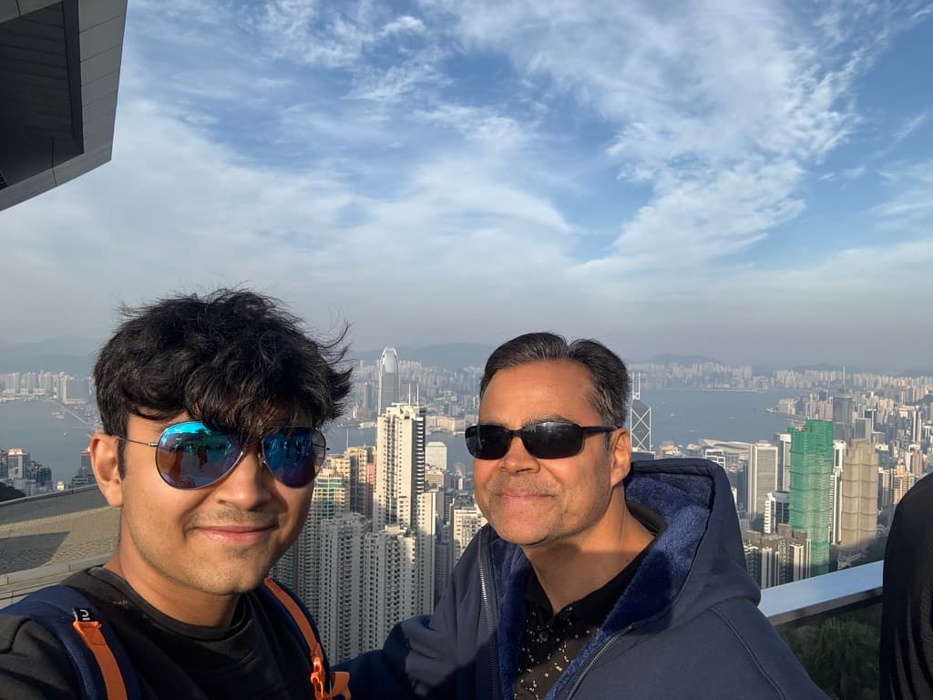 Naman at The Peak in Hong Kong, the skyline behind